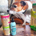 Load image into Gallery viewer, Dog enjoying Zeal® Hoki Fish Oil on food"
